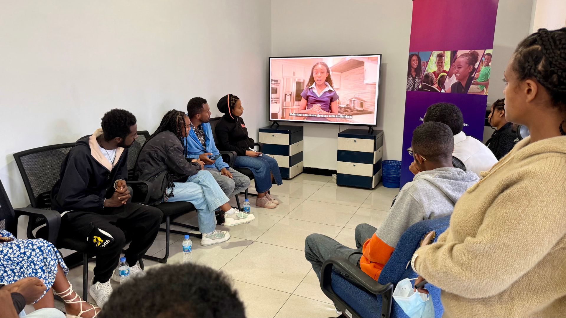 Team members of TaYA in Ethiopia watching a Teen2Teen video on clean drinking water
