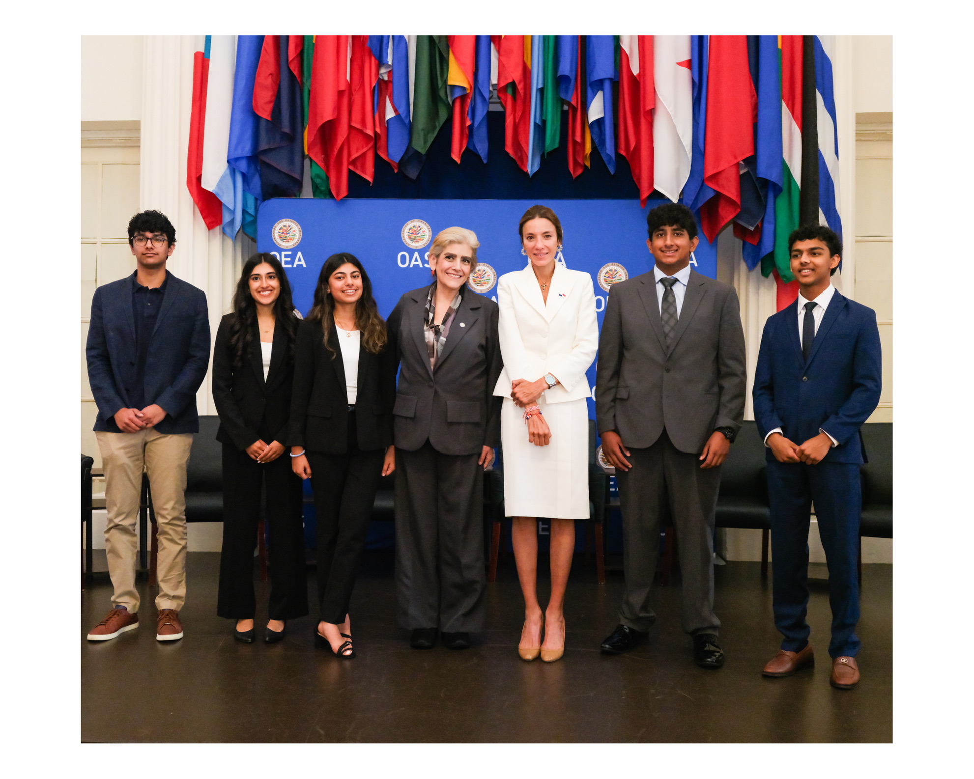 IYLC students with OAS representatives in front of the member-state flags