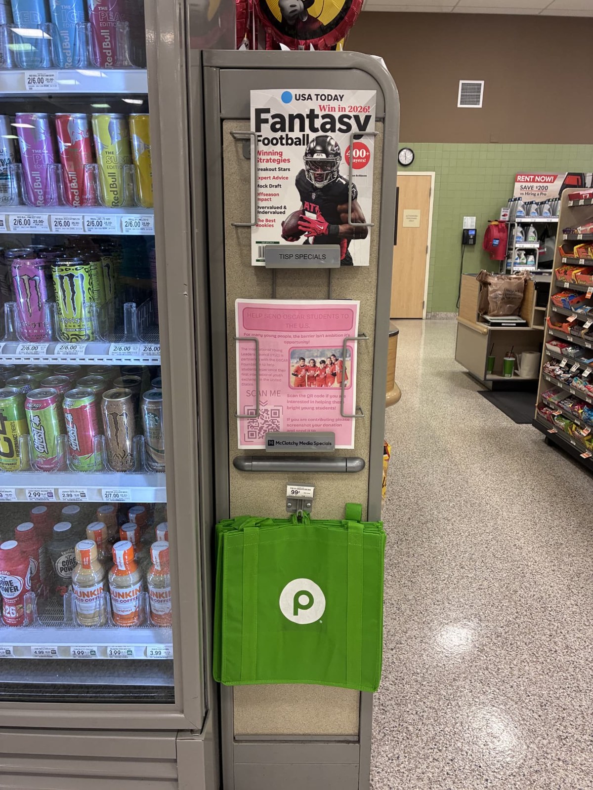 A pink OSCAR Foundation campaign flyer posted on a magazine rack inside a local Publix grocery store