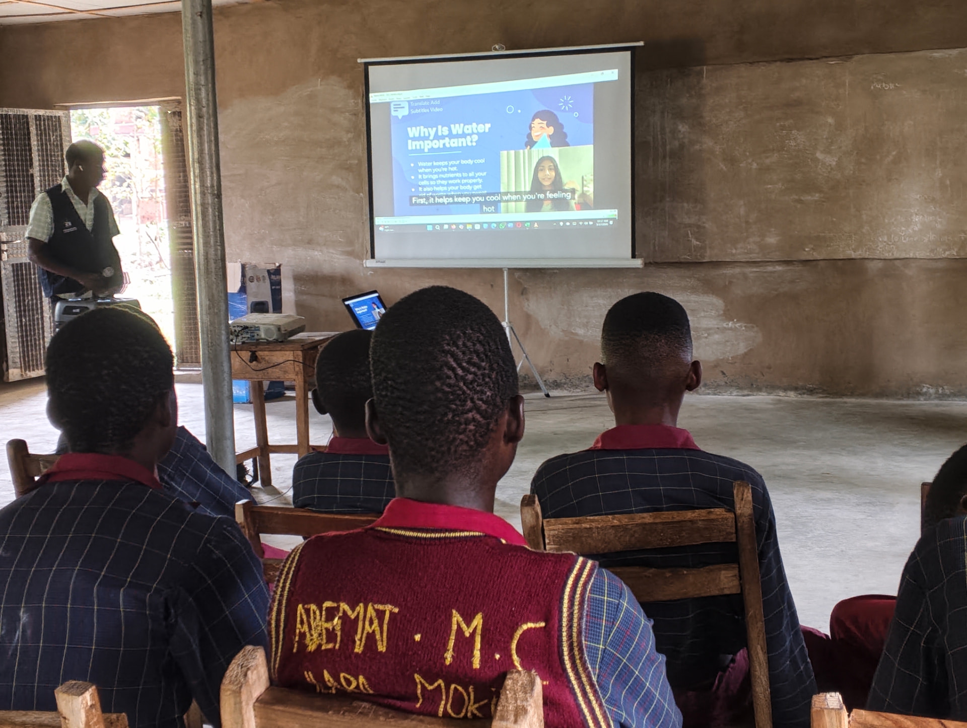 Students watching a Teen2Teen video titled Why Is Water Important projected in a classroom